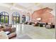 Spacious lobby featuring brick accent walls, arched entryways, ample seating, and sun-drenched windows at 1910 E Palm Ave # 10209, Tampa, FL 33605