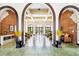 Grand lobby featuring arched entryways, exposed brick accents, and seating areas bathed in natural light at 1910 E Palm Ave # 10209, Tampa, FL 33605