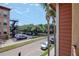 An overview of a brick-paved parking area showcasing the building's exterior, visible from a cozy balcony at 1910 E Palm Ave # 10209, Tampa, FL 33605