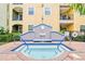Community spa with tiled fountain and updated pool with blue trim and brick base, offers a relaxing space at 1910 E Palm Ave # 10209, Tampa, FL 33605
