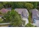 Aerial view of a charming house with a driveway, and beautifully manicured landscaping at 19207 Autumn Woods Ave, Tampa, FL 33647