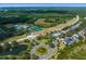Beautiful community aerial view featuring pool, tennis courts and beautiful winding road in a lush green landscape at 19207 Autumn Woods Ave, Tampa, FL 33647