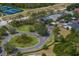 Aerial view of a gated community featuring lush green landscaping and beautiful winding roads at 19207 Autumn Woods Ave, Tampa, FL 33647
