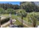 Large backyard with a pond, patio, and lounge seating at 19207 Autumn Woods Ave, Tampa, FL 33647