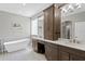 This bathroom features a soaking tub, double vanity, and a glass block window at 19207 Autumn Woods Ave, Tampa, FL 33647