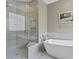 This bathroom showcases a glass shower, soaking tub, and tiled walls at 19207 Autumn Woods Ave, Tampa, FL 33647