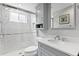 This bathroom features a walk-in shower and a vanity with a granite countertop at 19207 Autumn Woods Ave, Tampa, FL 33647