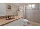 This bathroom features a shower with glass doors and a granite countertop at 19207 Autumn Woods Ave, Tampa, FL 33647
