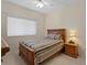 This bedroom has carpet, a ceiling fan, and a wood frame bed at 19207 Autumn Woods Ave, Tampa, FL 33647