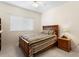This bedroom has carpet, a ceiling fan, and a wood frame bed at 19207 Autumn Woods Ave, Tampa, FL 33647