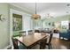 Bright dining area with view of the backyard, open to the living room and kitchen at 19207 Autumn Woods Ave, Tampa, FL 33647
