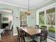 Charming dining area with view of backyard, adjacent to living room and kitchen at 19207 Autumn Woods Ave, Tampa, FL 33647