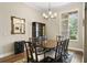 Elegant dining room with hardwood floors, large windows, and classic chandelier at 19207 Autumn Woods Ave, Tampa, FL 33647