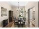 Bright dining room featuring hardwood floors, classic chandelier, and archway to other rooms at 19207 Autumn Woods Ave, Tampa, FL 33647
