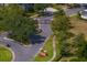 View of gated entrance to a landscaped community with manicured lawns and mature trees at 19207 Autumn Woods Ave, Tampa, FL 33647
