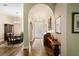 Elegant foyer features an arched doorway, hardwood floors, and views into the dining room at 19207 Autumn Woods Ave, Tampa, FL 33647