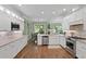 Open kitchen with hardwood floors, stainless appliances, granite counters, and eat-in breakfast nook at 19207 Autumn Woods Ave, Tampa, FL 33647