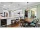Modern kitchen with granite countertops, stainless steel appliances, and adjacent dining area at 19207 Autumn Woods Ave, Tampa, FL 33647