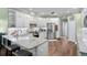 Beautiful kitchen with stainless appliances, white cabinetry, granite countertops, and an island with seating at 19207 Autumn Woods Ave, Tampa, FL 33647