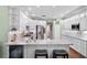 Modern kitchen boasts granite countertops, stainless steel appliances, wine cooler and white cabinetry at 19207 Autumn Woods Ave, Tampa, FL 33647