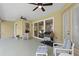 Relaxing screened lanai with ceiling fans, outdoor seating and grill, offering serene views of the backyard at 19207 Autumn Woods Ave, Tampa, FL 33647