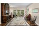 Elegant living room showcasing hardwood floors, a large rug, and a view of the outdoor scenery through sliding doors at 19207 Autumn Woods Ave, Tampa, FL 33647