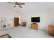 Spacious living room with a ceiling fan, featuring ample natural light and storage at 19207 Autumn Woods Ave, Tampa, FL 33647