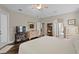Bright main bedroom with ceiling fan, hardwood floors, and private outdoor access at 19207 Autumn Woods Ave, Tampa, FL 33647