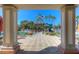 Community pool view featuring a tower with slide, palm trees, lounge chairs, and well-manicured landscaping at 19207 Autumn Woods Ave, Tampa, FL 33647