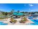 Overhead view of community pool with lush landscaping and lounge seating at 19207 Autumn Woods Ave, Tampa, FL 33647