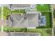 Aerial view of a beautiful home featuring a screened-in pool and backyard entertainment area at 19400 Roseate Dr, Lutz, FL 33558