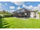 View of screened-in back patio from spacious artificial turf backyard at 19400 Roseate Dr, Lutz, FL 33558