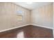Bedroom featuring wood floors, neutral paint and bright light from the window at 19400 Roseate Dr, Lutz, FL 33558