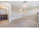 Bedroom with neutral carpet, lighting, and an attached bathroom featuring a granite countertop at 19400 Roseate Dr, Lutz, FL 33558