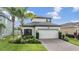 Charming two-story home with a well-maintained lawn and landscaping at 19400 Roseate Dr, Lutz, FL 33558