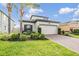 Charming single-Gathering home with a well-manicured lawn and a two-car garage, embodying curb appeal at 19400 Roseate Dr, Lutz, FL 33558