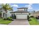 Charming two-story home with a well-maintained front yard and brick driveway at 19400 Roseate Dr, Lutz, FL 33558