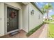 Stylish front door adorned with a wreath, creating a warm and inviting entrance at 19400 Roseate Dr, Lutz, FL 33558
