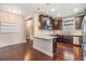 Modern kitchen with dark cabinets, granite countertops, and stainless steel appliances at 19400 Roseate Dr, Lutz, FL 33558