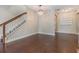 Open living room featuring wood floors, modern lighting and a staircase to the second level at 19400 Roseate Dr, Lutz, FL 33558