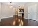 Spacious living room with elegant lighting fixtures and seamless flow to the kitchen at 19400 Roseate Dr, Lutz, FL 33558