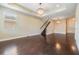 Inviting living space featuring dark hardwood floors and an elegant staircase at 19400 Roseate Dr, Lutz, FL 33558