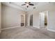 Spacious carpeted main bedroom with tray ceilings, ceiling fan, and ample closet space and attached bathroom at 19400 Roseate Dr, Lutz, FL 33558