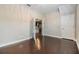 Well lit office featuring wood floors and french doors with a view into the kitchen at 19400 Roseate Dr, Lutz, FL 33558