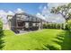 Spacious screened patio with ample seating and view of the green backyard at 19400 Roseate Dr, Lutz, FL 33558