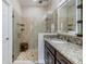 Close up of the glass shower featuring river rock flooring, built in shelves and multiple shower heads at 19400 Roseate Dr, Lutz, FL 33558