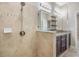 Close up of the glass shower featuring tile walls, built in shelves and a rain shower head at 19400 Roseate Dr, Lutz, FL 33558