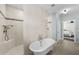 Bright bathroom featuring a soaking tub, tiled shower and neutral tile flooring at 2303 S Occident St, Tampa, FL 33629