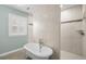 Bright bathroom featuring a soaking tub, tiled wall and large window with plantation shutters at 2303 S Occident St, Tampa, FL 33629