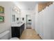 Bathroom with black vanity and long mirror that leads to office space at 2303 S Occident St, Tampa, FL 33629